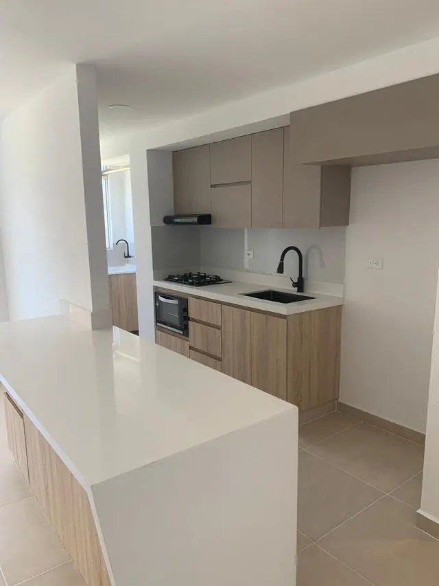 Cocina integral moderna con isla en cuarzo blanco